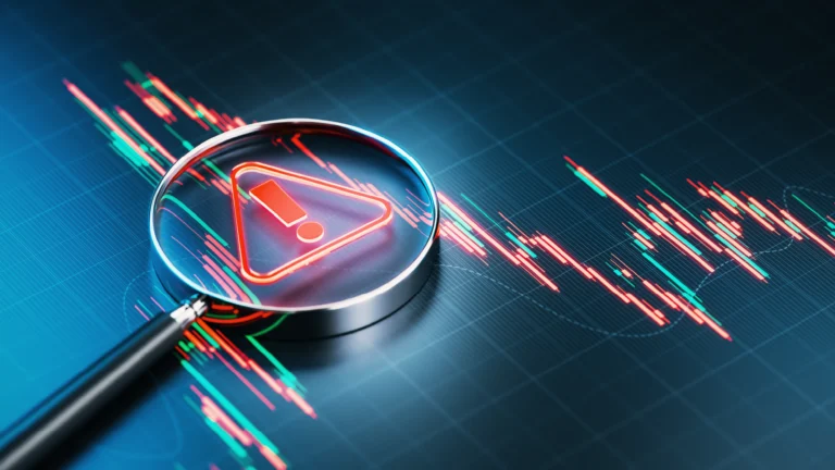 Magnifying glass highlighting a warning symbol over red and green candlestick-chart graphics, representing portfolio risk and market volatility.