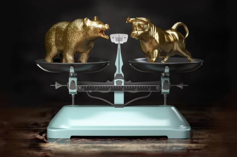 gold bull and bear on a weighing scale