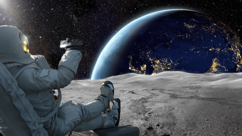 Astronaut sitting on the moon looking at Earth