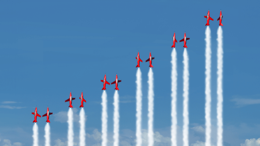 Six pairs of red fighter jets all climbing vertically, increasing in height from left to right