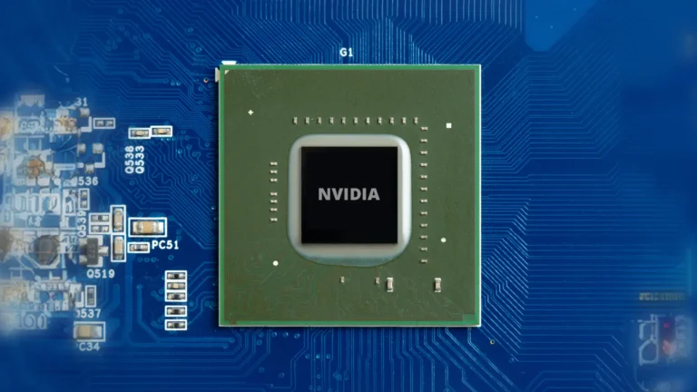 Green computer chip that says Nvidia in the middle, on a blue motherboard background