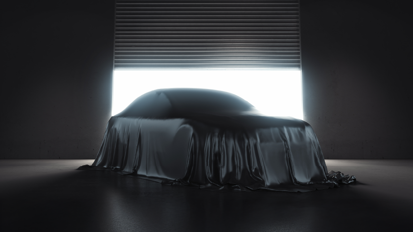 a car under a tarp waiting to be revealed