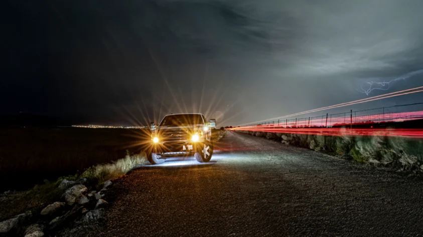 Ford truck at night with headlights on
