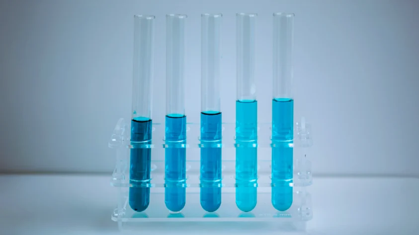 Test tubes with blue biotech liquid