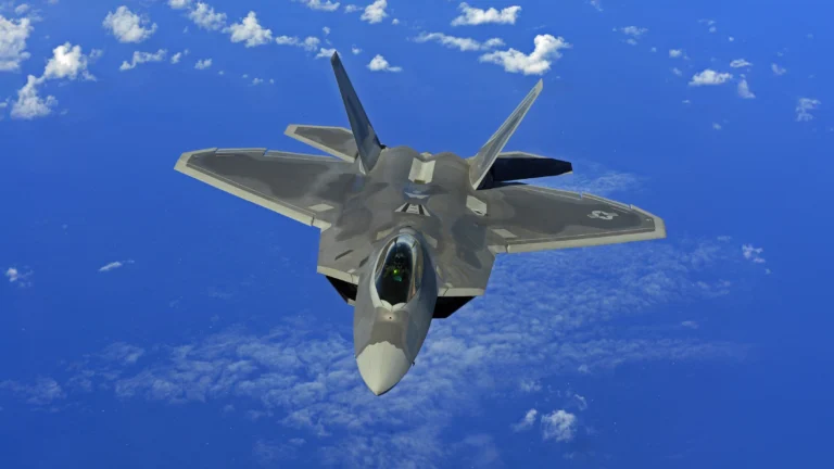 A fighter jet flying through a blue sky